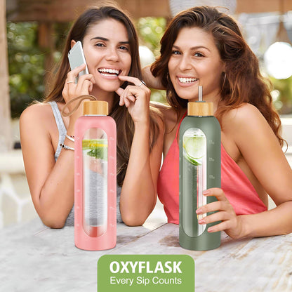 OxyFlask Glass Water Bottles 32 oz - Motivational Drinking Glass Water Bottle with Silicone Sleeve, Straw & 2 Bamboo Lids - 1 Liter Clear Borosilicate Daily Intake Tumbler with Time Marker - Olive